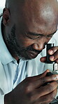 Science, study or black man in lab with microscope, investigation or sample check in experiment. Test, cell analysis or scientist with equipment, medical research or inspection in clinical trial.