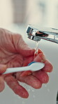 Toothbrush, water or senior hands with denture in bathroom, oral hygiene or morning routine for wellness. Dental care, bacteria removal or old person by sink to clean fake teeth, fresh breath or home