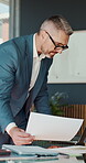 Reading, man or laptop with documents in office for data analysis, policy update or forecasting. Finance manager, mature person or tech with statement for financial reporting, compare stats or review