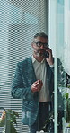 Window, man and talking with phone call in office for debt review, market update or negotiation. Financial advisor, mature person and mobile contact for risk management, explain policy or loan advice