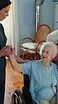 Caregiver, stretching and old woman in nursing home with wheelchair, mobility assessment and discussion. Nurse, physiotherapy and elderly person with disability, check arm injury and medical support.