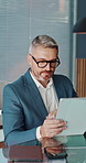 Happy, man and review on tablet in office for reading income report, market trends and research. Financial analyst, mature person and tech for investment proposal, monitor performance or finance news