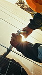 Hands, man and maintenance with solar panels in field for renewable energy, electricity and sustainability. Tools, engineer and photovoltaic farm for inspection, eco friendly power system and flare