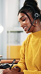 Happy woman, writing and talking with headset in call center office for online referral or advice. Female person, consultant or agent speaking with smile, notes or mic for virtual assistance or help
