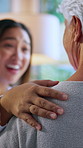 Hands, nurse and elderly care with conversation in home with support, story and happy in living room. Senior person, caregiver and connection with touch, laugh and funny discussion in retirement