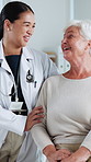 Hospital, talking and doctor with senior woman in consultation, checkup and appointment. Healthcare, discussion and person with elderly patient for diagnosis, medical service and advice in clinic