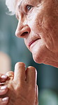 Wedding ring, thinking and senior woman in home with nostalgia, memory or loneliness in living room. Sad, reflection and elderly female person with marriage jewelry for grief with daydreaming.