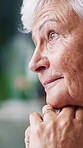 Walking stick, nostalgia and senior woman in home with thinking, memory or loneliness in living room. Sad, reflection and elderly female person with wooden cane for medical aid with daydreaming.