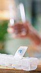 Pills, container and hands with water in home for healthcare supplements, vitamins or minerals. Person, glass and box for pharmaceutical product, drugs and wellness with dosage schedule at apartment