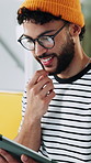 Creative, man and thinking in office with tablet, review project and proposal for digital marketing. Person, glasses and scroll in workplace with tech, research and planning for advertising campaign.