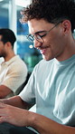 Glasses, typing and man in office with research for programming, coding or system upgrade. Professional, happy and male coder with web development, firewall or cybersecurity project at startup agency