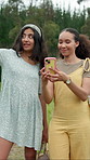 Nature, direction and girl friends with phone on mobile app for navigation, route planning or research. Happy, technology and female people on cellphone for digital map outdoor in forest on holiday.