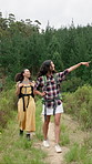 Backpacking, hiking and friends pointing in nature with adventure, discovery or exploring on vacation. Happy, outdoor and female people trekking for travel with health, wellness or bonding on holiday