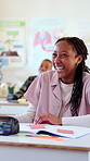 Teenage girl, funny and student in classroom, learning and development with academic success. High school, education and person with happiness, laughing and answer for assessment questions and smile