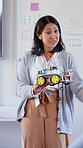 Teacher, robotics and woman with car in classroom for STEM education, knowledge or demonstration. Mechanical engineering, educator and transport model in high school for learning, science and lesson