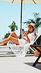 Woman, phone and laugh with deck chair for vacation, rest and relax for trip or break. Luxury resort, social media and person with travel, weekend and smile for hotel accommodation or hospitality