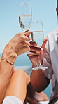Hands, cheers or couple with wine at resort, anniversary celebration trip or travel holiday for bonding. Outdoor, alcohol or people with toast for relationship milestone, vacation or romantic getaway