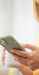Hands, phone and woman in home with coffee for social media, internet and online chat on weekend. House, relax and person on smartphone for typing message, website and connection with warm beverage