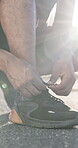 Fitness, shoes and tying laces with hands of man outdoor for runner, getting ready and health. Wellness, training start and athlete with sneakers of person in road for sports, workout and exercise