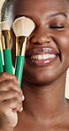 Smile, makeup brush and beauty with black woman in studio for self care, glow and foundation. Cosmetics, highlighter shine and cosmetology with person on white background for eyeshadow and blush