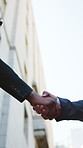 Business people, meeting and handshake with greeting in city for partnership, agreement or deal. Low angle, employees or colleagues shaking hands with b2b for teamwork or introduction in urban town
