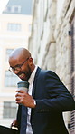Excited, businessman and dancing with coffee in city, accountant and happy for financial development. Outdoor, walk and black person with latte on street, laughing and celebration for investment