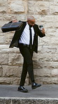 Happy, businessman and dancing with coffee in city, accountant and excited for financial development. Outdoor, travel and black person with latte on street, achievement and celebration for investment