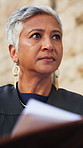 Judge, woman and documents in city for court case, folder and insight in street with legal career. Mature person, magistrate and law professional with thinking, paperwork and justice with report