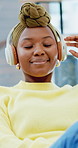 Home, happy and black woman with headphones on sofa for listening to music, audio and playlist. Apartment, relax and person with subscription for streaming media, radio and track to chill on weekend