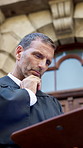 Thinking, lawyer and man in city, documents for trial verdict and policy legislation. Outdoor, attorney paperwork and mature person in street, reading and decision for justice, research and choice
