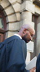 Lawyer, conversation and men in city, back and planning for compliance review. Judge, outdoor and people in street, legal case and criminal investigation with court portfolio and support for research