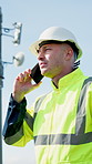 Phone call, talking and man with solar panels in city for installation, maintenance and inspection. Rooftop, electricity and person on cellphone for feedback, chat and update for renewable energy