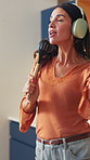 Woman, headphones and singing with spoon in kitchen with sound, streaming song and happy in home. Mature person, voice and rhythm with dance, audio and listen to music with subscription at apartment