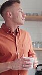 Morning, man and thinking with coffee in kitchen, serious and decision with warm beverage on weekend. Home, reflection and person with tea on break, remember and daydreaming with drink and thoughtful