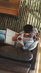 Drink, reading book and above of woman on sofa for literature, hobby and relax on weekend. Home, rest and person on couch with beverage for story, novel and chapter with calm, peaceful and me time