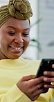 Laugh, texting and black woman in living room with phone, online connection and meme post on social media.  Happiness, typing and person in house with tech, funny message or gif reaction on chat app
