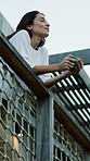 Happy, balcony and woman with drink outdoor for fresh air, reflection and perspective in morning. Home, relax and person with beverage for calm, peace and breathe for rest, wellness and inspiration
