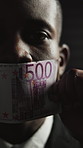 Man, face and cash on mouth for silence with fraud, corruption and dark office with financial crime. Person, money laundering and portrait in closeup for scam, stealing or corporate theft in Nigeria