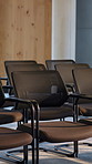 Boardroom, empty and row of chairs for workshop, corporate event and seminar. Professional, conference and seats in business venue for convention, presentation and management meeting in office