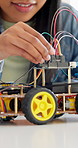 Hands, robotics and classroom in school for students, discussion or future development. People, wiring and education with electronics, transportation or machine for knowledge or engineering project