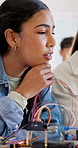 Girls, robotics and discussion in school for students, learning or future development. People, wiring and education with electronics, transportation or machine for knowledge or engineering project