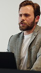 Conference, speech and man with laptop for presentation, workshop event and skills training. Meeting, speaker and people in seminar, convention or business coaching for company development in office