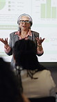 Woman, presentation and audience at convention with screen, graphs and discussion for market share growth. Mature person, CEO and projector with insight, stats and charts with seminar at sales agency