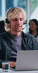 Laptop, help desk and man in call center for technical support, network troubleshooting or typing. Headset, computer or happy person in office for customer service, IT or internet connection feedback