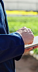 Hands, farmer and reading with tablet in greenhouse for research, agriculture and growth checklist. Person, scroll and food production with digital, online inventory and quality assurance for harvest