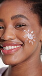 Face, beauty and woman with sunscreen in studio for UV protection, healthy glow and skin benefits. Happy, black girl and SPF cream on white background for moisturizer, self care and skincare routine