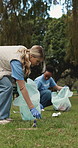 Park, volunteer or people with trash bag for cleaning, ngo recycling drive or climate action project. Nature, responsibility or women with eco protection initiative, pick up litter or sustainability