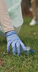 Grass, plastic or hands with trash bag for cleanup, land pollution or ngo recycling drive for climate action. Park, rubbish or person with eco conservation project, pick up litter or sustainability