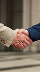 Business people, meeting and city with handshake for partnership, agreement or outdoor deal. Employees, colleagues or shaking hands with introduction or greeting for onboarding or b2b in urban town