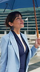 Thinking, walk or businesswoman in city with umbrella, fresh air or mindfulness in morning commute. Stroll, daydream or mature employee with shield, urban journey or positive mindset at start of day.